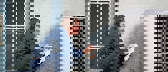 An HVAC technician is performing routine maintenance